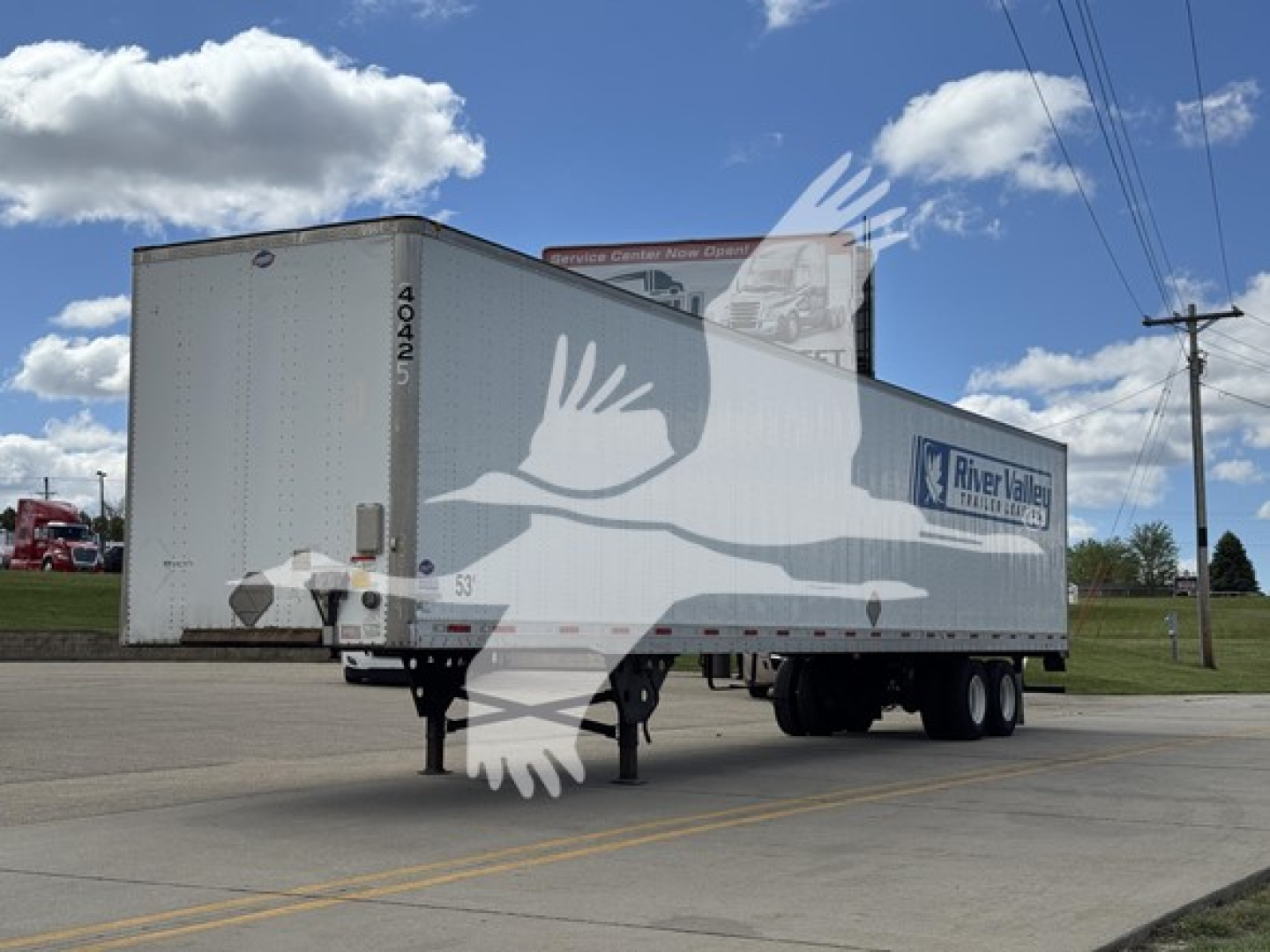 Trailer side view of a 2014 Utility 4000Dx box trailer with River Valley logo, parked on a lot; front hitch and dual rear axles visible.
