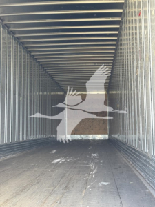 Trailer interior of a 2014 Utility 4000Dx trailer showing metal side rails and wooden floor, empty cargo bay.