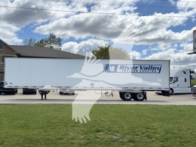 Trailer side of a 2014 Utility 4000Dx with a River Valley Trailer Leasing logo, white exterior, under a partly cloudy sky.
