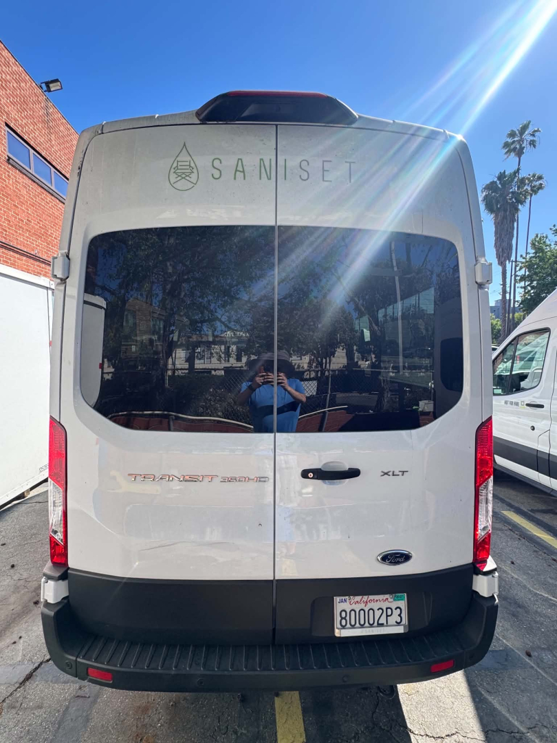 Ford Transit 350 HD rear view showing dual back doors with Saniset logo and XLT badge.