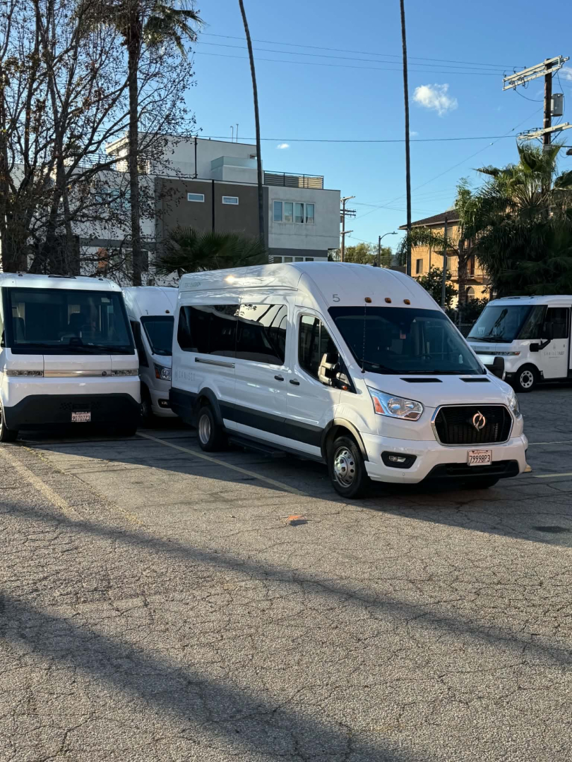 Ford Transit 350 HD cargo/passenger van in white, angled front-right view in a lot with other vans, 2022 model year, V6/transit styling visible.