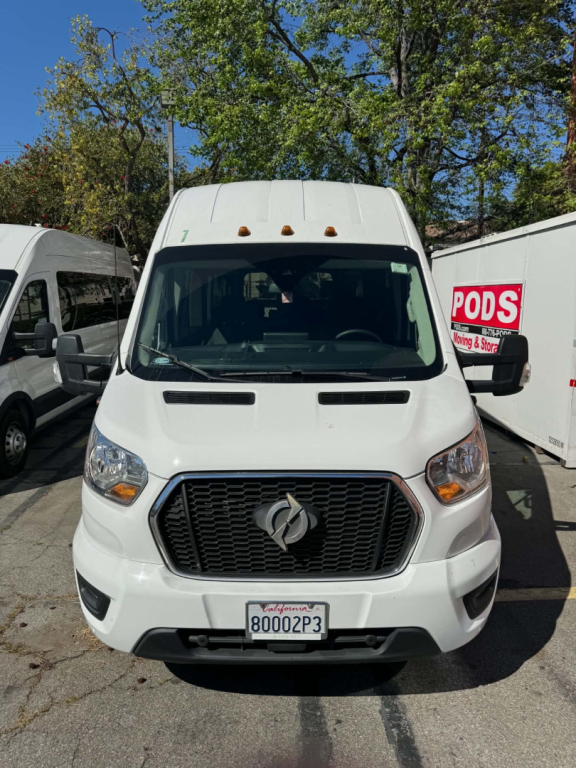 Front view of a white 2022 Ford Transit 350 HD passenger van with black grille, Ford emblem, headlights, and license plate 80002P3.