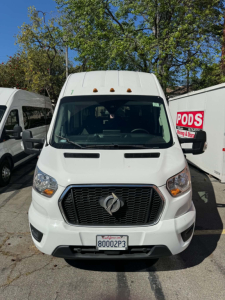 Front view of a white 2022 Ford Transit 350 HD passenger van with black grille, Ford emblem, headlights, and license plate 80002P3.
