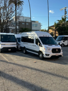 Ford Transit 350 HD cargo/passenger van in white, angled front-right view in a lot with other vans, 2022 model year, V6/transit styling visible.