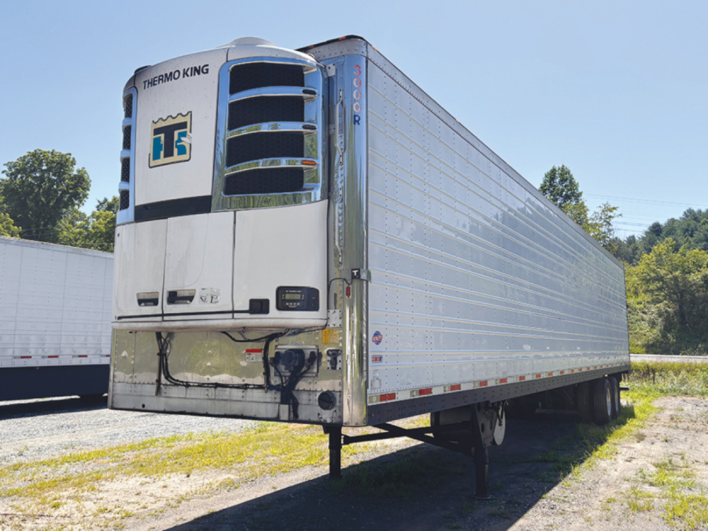 Thermo King unit on front of a 2014 Utility 3000R refrigerated trailer with silver corrugated sides and dual rear wheels.