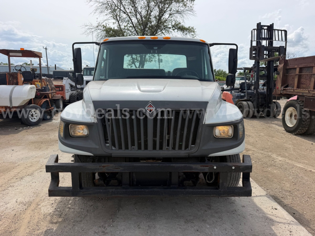 Truck front view showing International TerraStar SFA 4x2 with bold grille, headlights, and front bumper; visible cargo/dump truck setting.