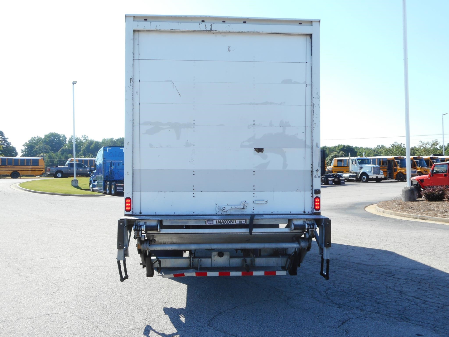 Freightliner M2 106 box truck rear view showing liftgate and bumper with reflective tape