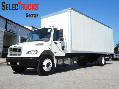 Box truck with a large white cargo box on a chassis, front cab showing Freightliner-style grille, used vehicle at SelectTrucks Georgia lot.