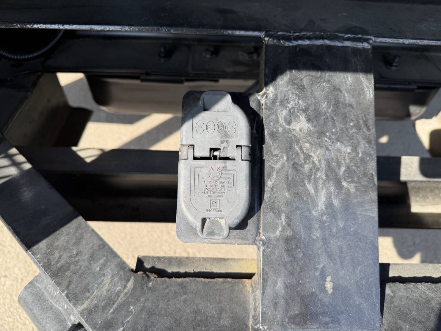 Chevrolet 6500 HD chipper truck front section showing electrical/warning plug cover and metal hitch area.
