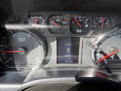 Dashboard of a 2023 Chevrolet 6500 HD showing rpm gauge, speedometer, and central digital display with Speed 0 MPH and P 571 mi.