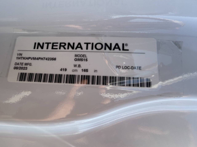 Vehicle label showing INTERNATIONAL GM5I5 model with VIN 1HTKHPVM4PH742356 and date 08/2023 on a white sticker