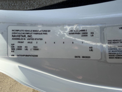 Label on vehicle door showing VIN 1HTKHPVM4PH742356, manufactured by Navistar, Inc., assembled in United States, GVWR 23500 lb, GAWRs and date 08/2023.