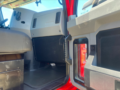 Cab interior of 2021 Mack AN64T truck showing dash panels and open doorway with cargo area edge.