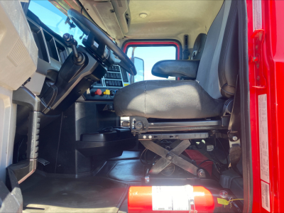Cab interior of a 2021 Mack AN64T truck showing driver seat, steering wheel, and dashboard with pedals and controls.