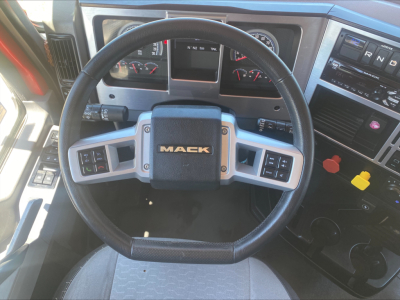 Mack AN64T dashboard and steering wheel showing Mack logo on center and instrument cluster.