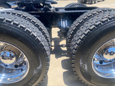 Mack AN64T truck rear tandem wheels showing dual tires and chrome rims.
