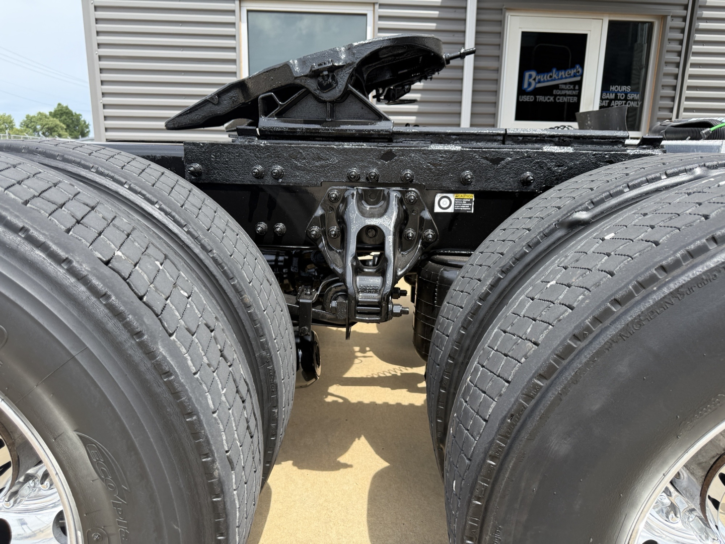 Peterbilt 579 chassis with dual rear axles and fifth wheel seen from behind showing hitch and frame.
