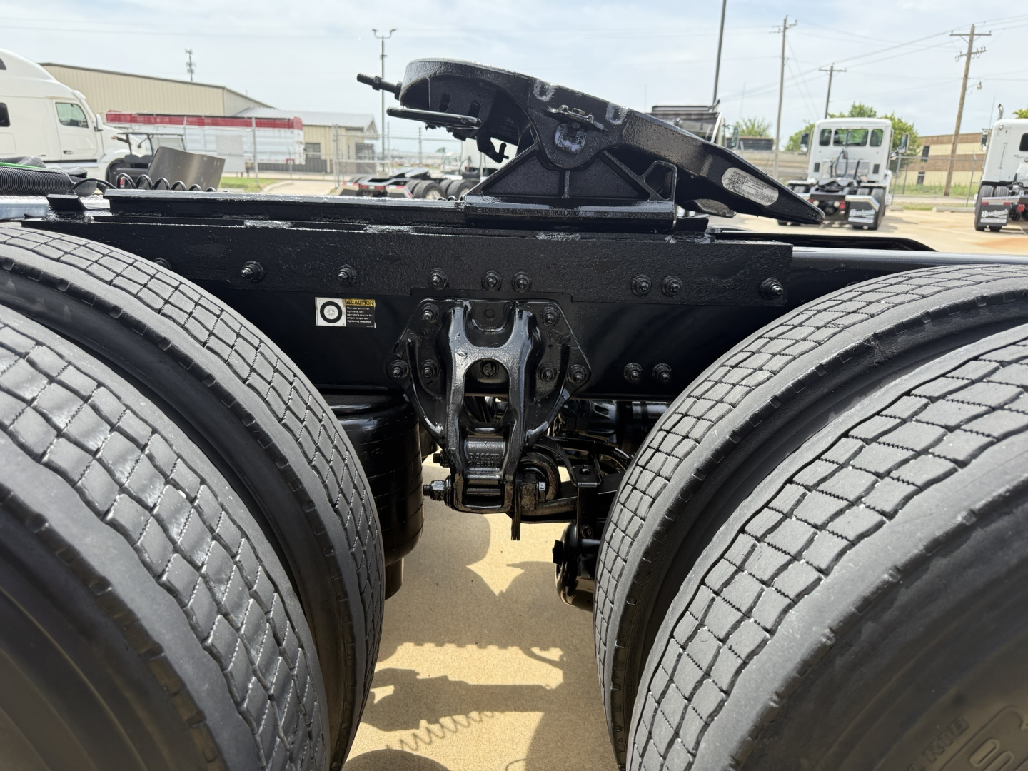 Peterbilt 579 truck chassis view showing rear dual-drive wheels, fifth wheel coupling, and air lines.
