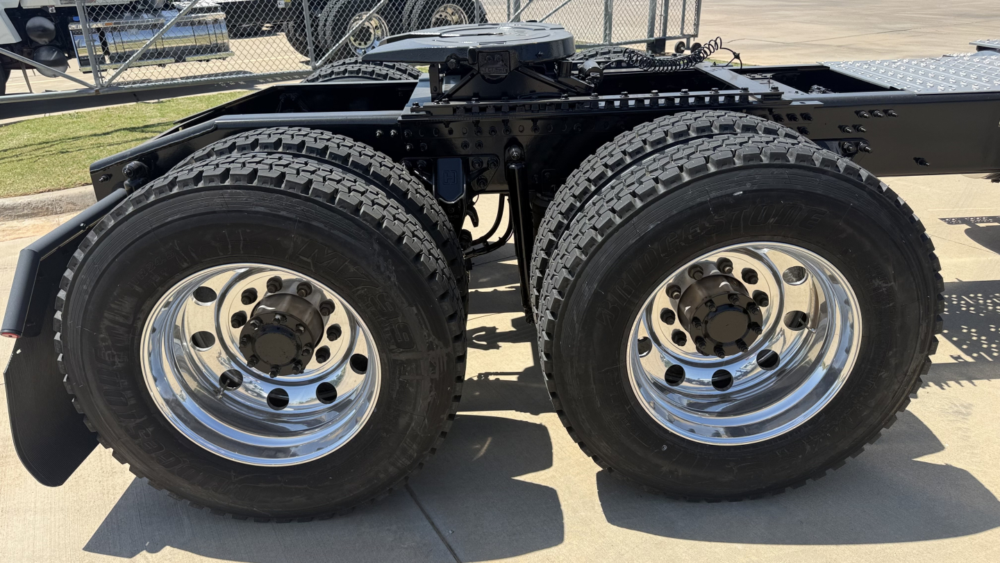 Dual rear wheels on a 2026 Mack PI64T truck chassis showing heavy-duty tires and chrome rims.