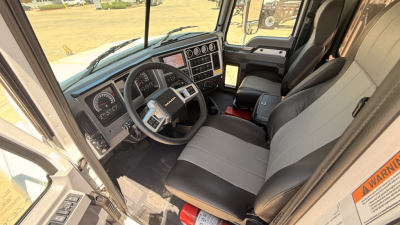 Cab interior of a 2026 Mack PI64T truck showing steering wheel, dashboard, and front seats.