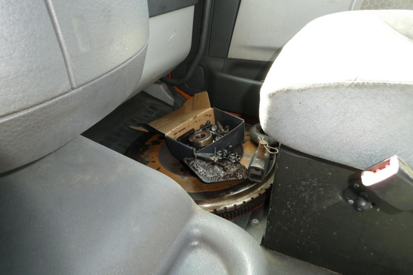 Volvo VNM42T cab interior showing exposed flywheel area and dashboard components in center console.
