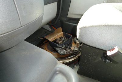 Volvo VNM42T cab interior showing exposed flywheel area and dashboard components in center console.