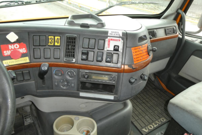  Volvo truck cabin dashboard with control switches and wood grain trim showing 34 gear indicator and No Smoking sticker.