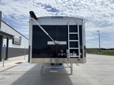 Stoughton aluminum grain hopper trailer rear view showing a 74" side height, ladder on right, rear door with crossbars, and a tilt chute with a support arm.