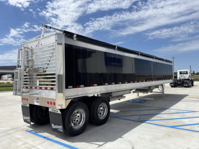 Trailer side view showing aluminum grain hopper trailer with 42' length, 74" sides, dual rear axles, and rear access ladder.