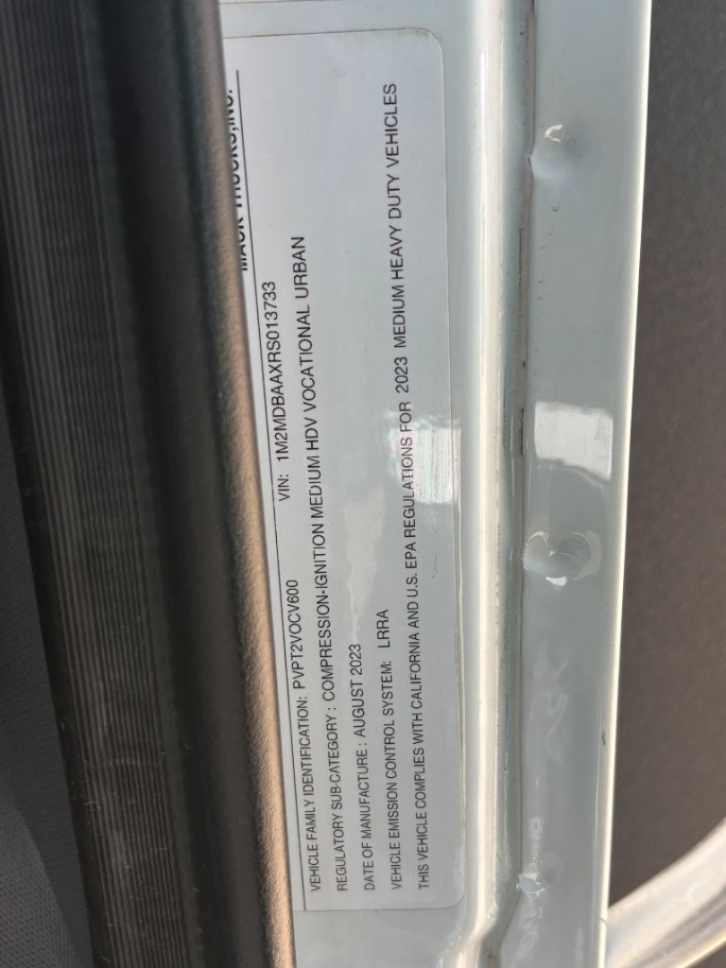 Mack MD6 service/utility truck door jamb label showing VIN and regulatory information.