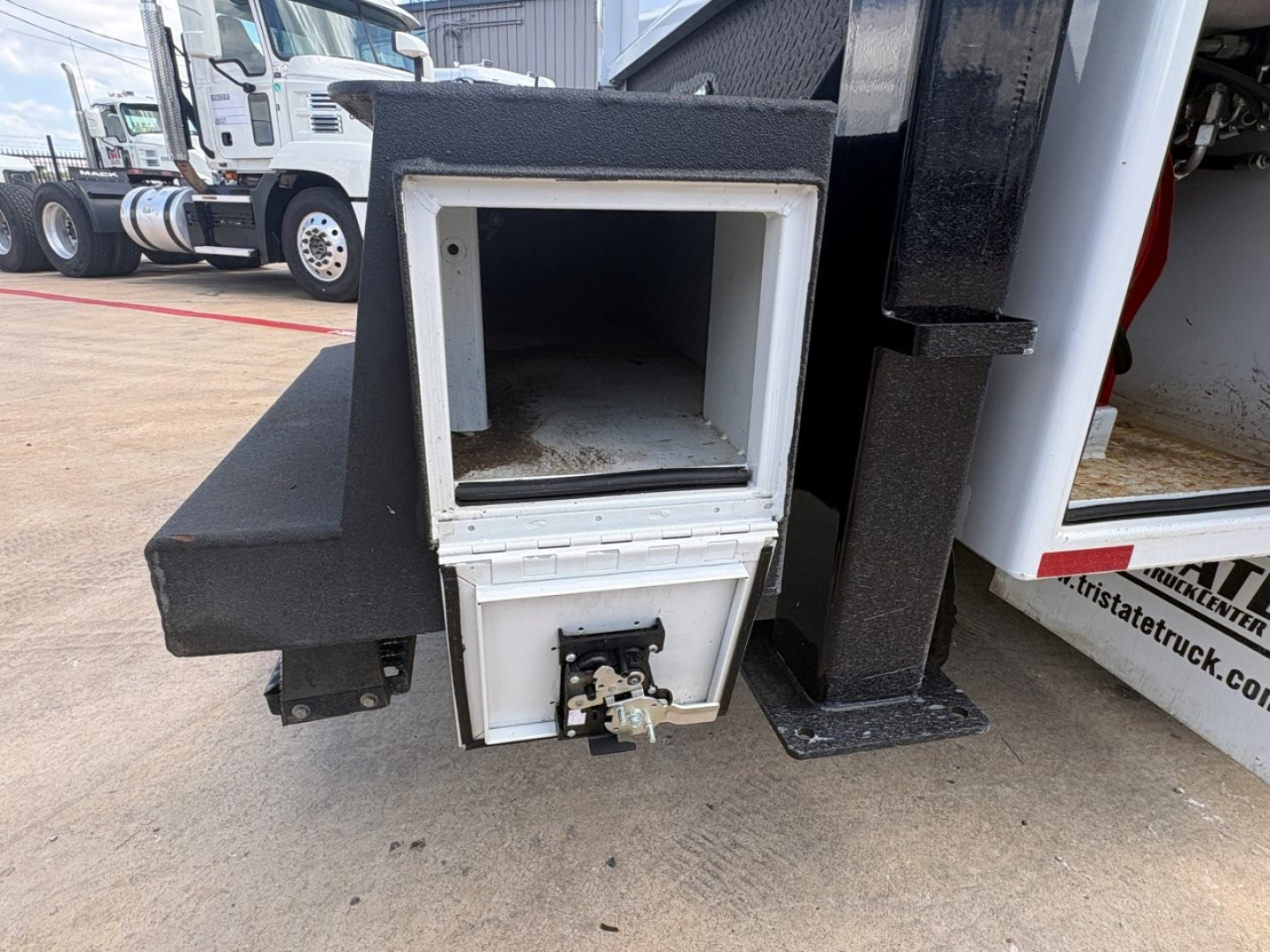 Mack MD6 component showing front storage compartment and draw latch, metal frame, and white inner opening.