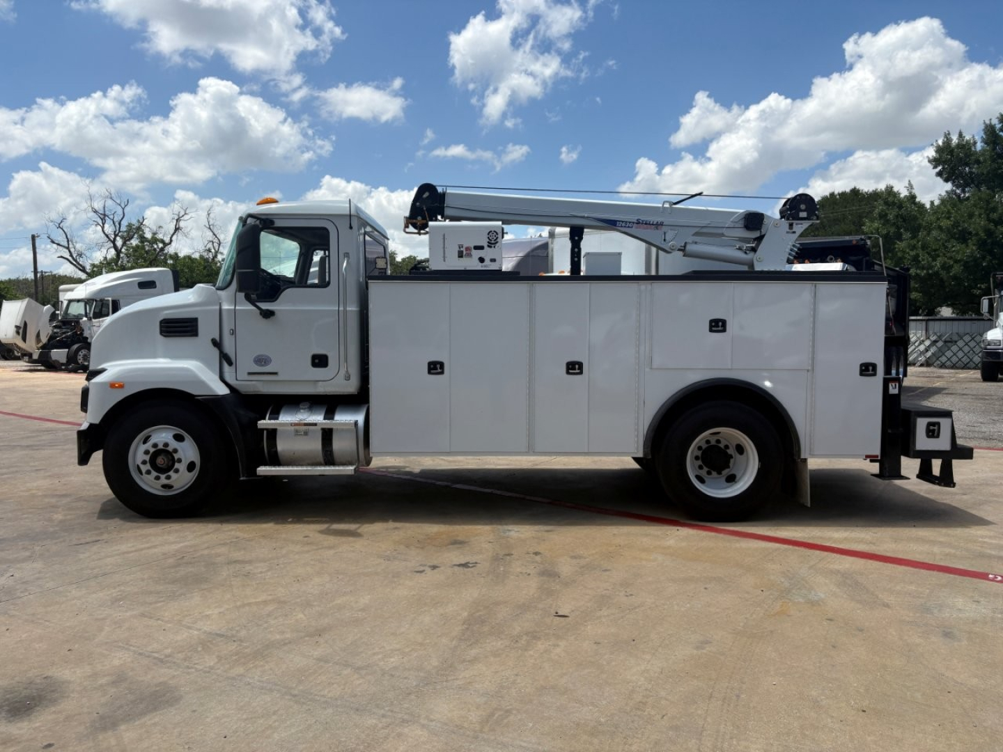 Service/utility truck Morgan Mack MD6 in-service utility body with box compartments and boom arm visible, side profile view.