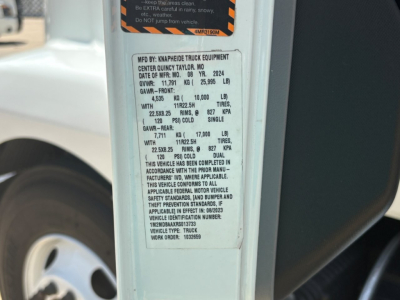 Mack MD6 service label on a door jamb showing MFD BY KNAHFEIDE TRUCK EQUIPMENT? CENTER QUICKY TAYLOR MO. DATE OF MFR: 08/24/2024 GVWR: 19,000 LB? GAWR FRONT and REAR values, tire and axle ratings, VIN 1M2MDBAAXRS013733, work order 103265.