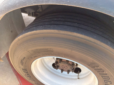 Mack MD6 wheel and tire close-up showing a heavy-duty rim and tire tread.