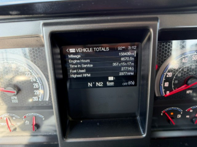 Dashboard display showing vehicle totals: Mileage 158,439 mi, Engine Hours 8,570.5 h, Time In Service 357 days 15 h 17 m, Fuel Used 27,714 gal, Highest RPM 2377, N N 2 gear indicator.