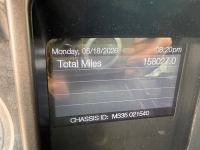 Mack GR64B cab dash display showing date, total miles 158,027.0, chassis ID M335 021540.