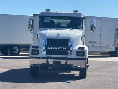 Mack MD7 truck front view showing large grille with MACK emblem and chrome bumper.