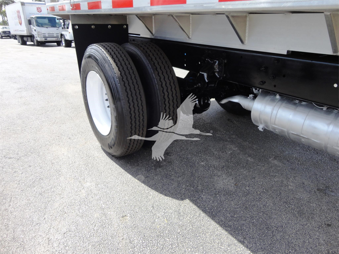 Freightliner M2 106 undercarriage showing dual rear wheels and fuel tank.