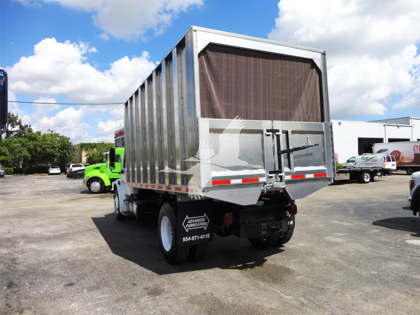 Freightliner M2 106 dump truck rear view showing cargo bed and rear bumper.