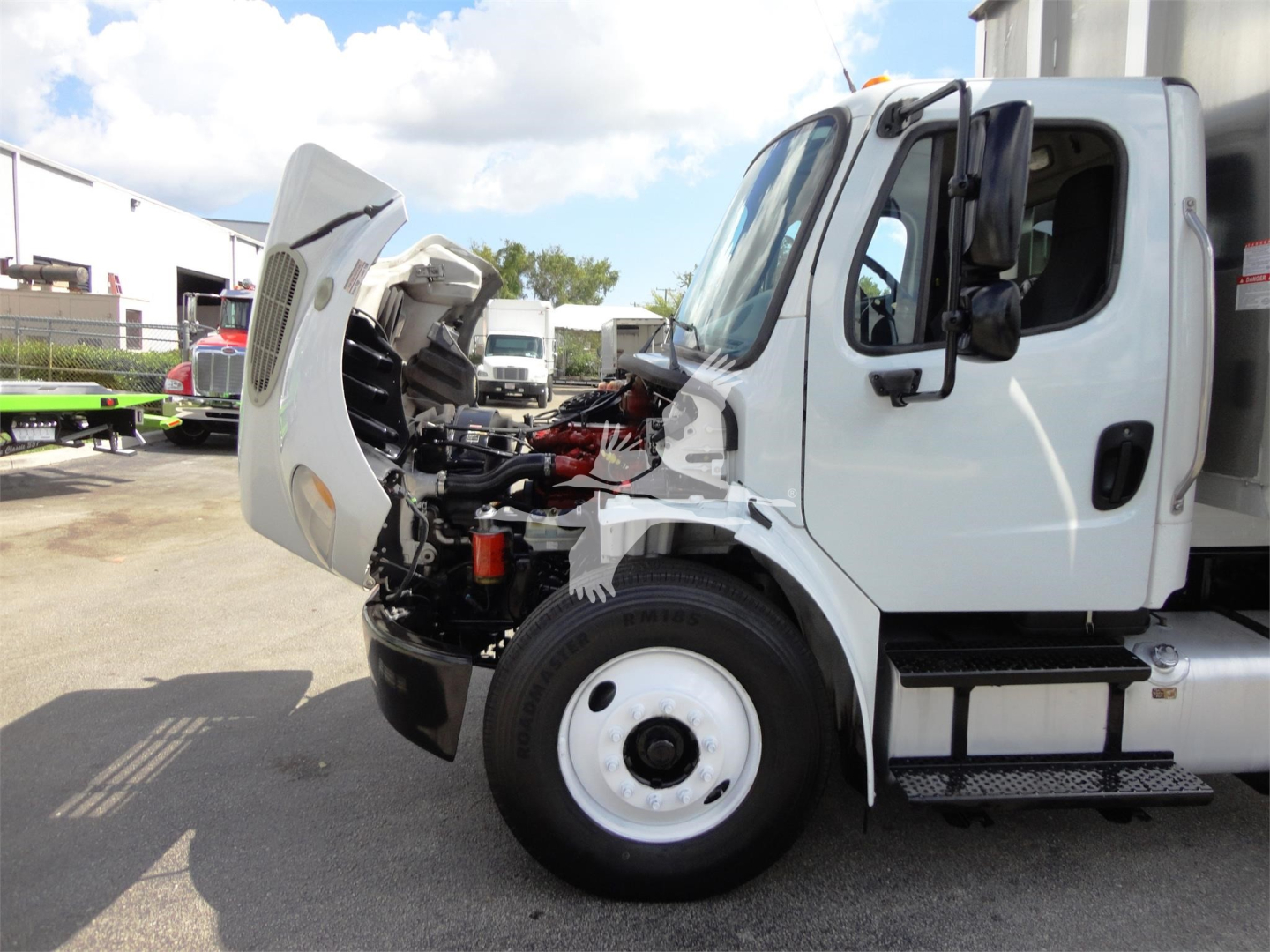 Front-left view of a 2014 Freightliner M2 106 with hood open, showing engine bay and cab area.