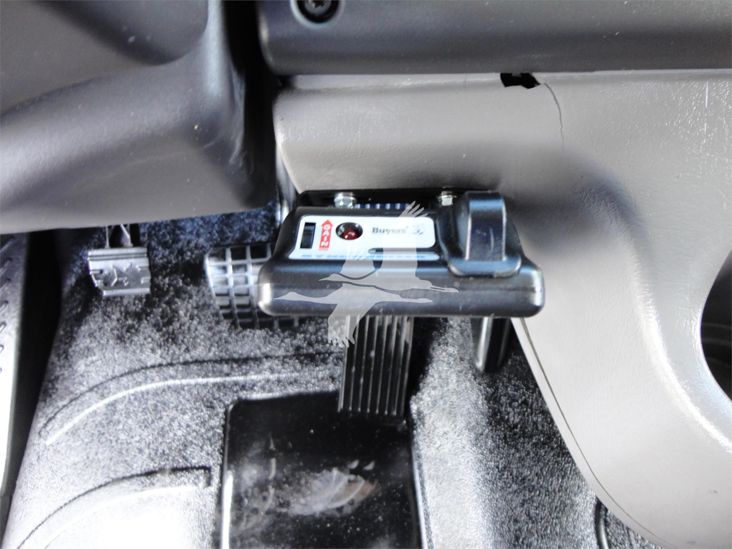 Cab area of a Freightliner M2 106 interior showing dash controls and accelerator pedal with label visible.