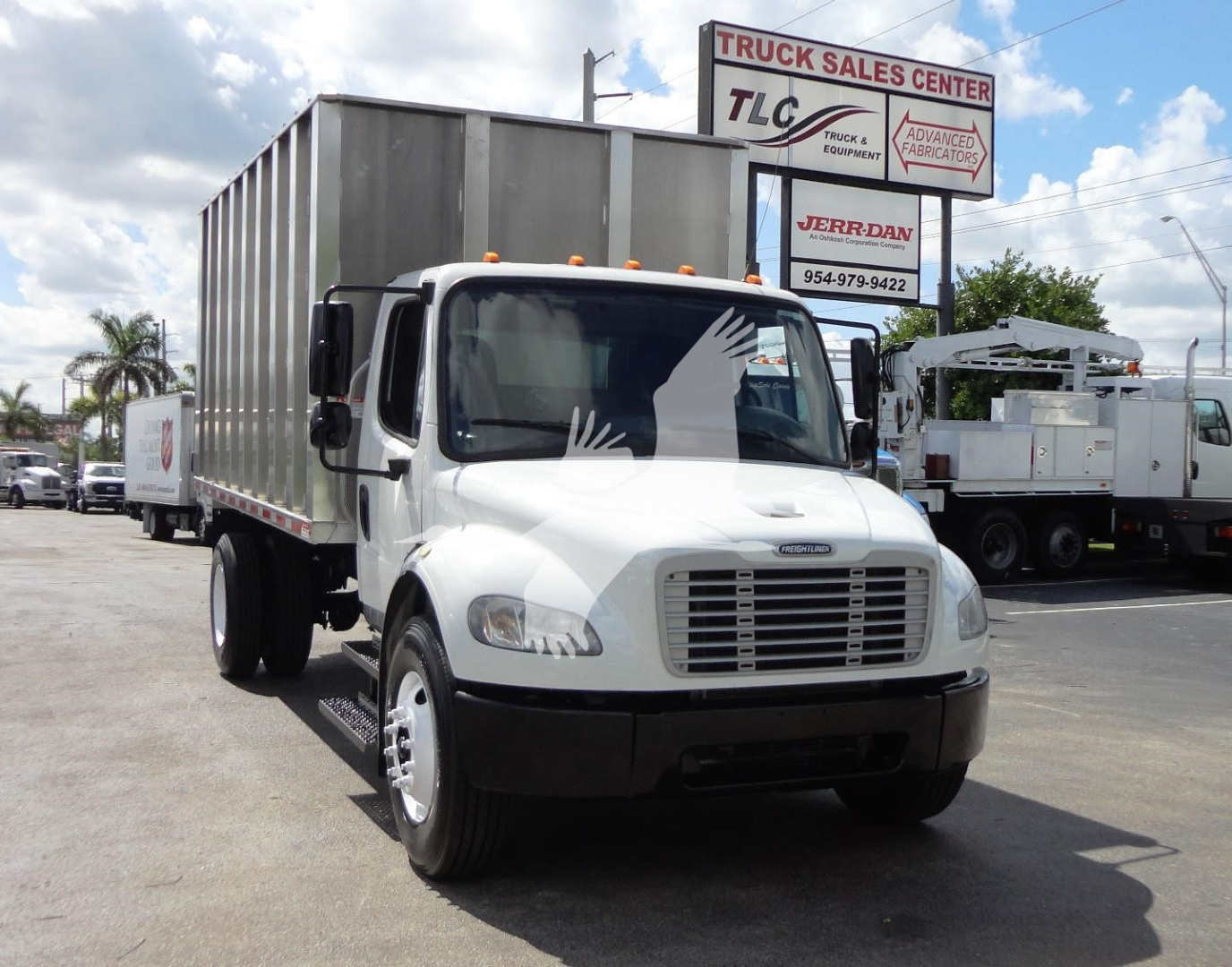 2014 Freightliner M2 106 truck with large silver cargo box, front view in dealership lot.
