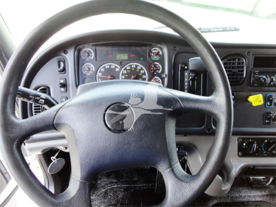 Dashboard view of Freightliner M2 106 steering wheel and instrument cluster.