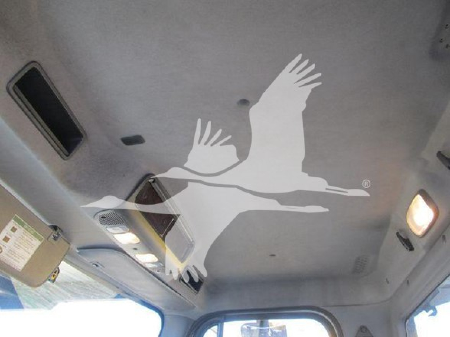 Cabin ceiling of a Freightliner M2 106 showing ventilation panels and a white graphic of a bird in flight.