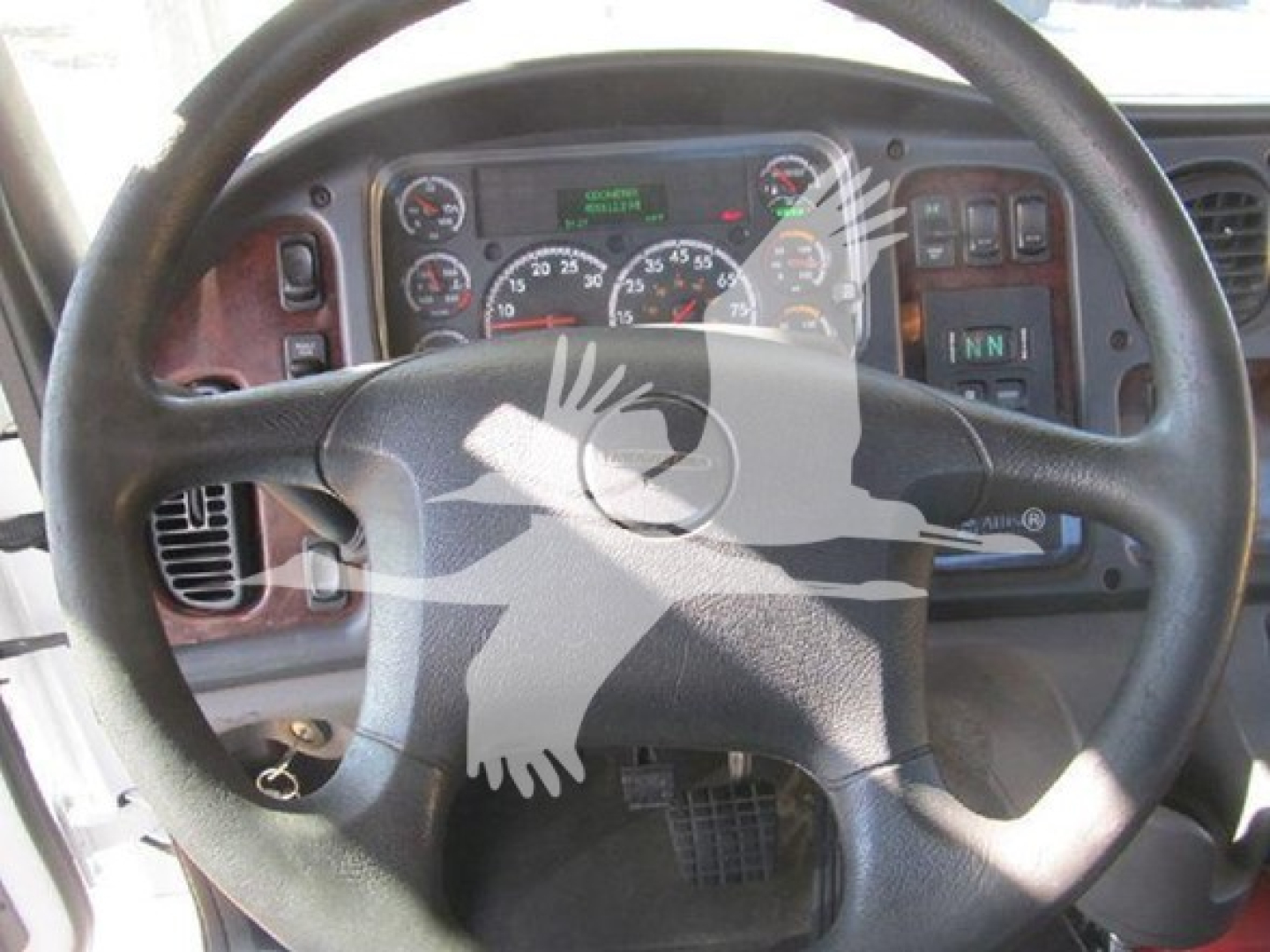 Steering wheel and dashboard of a Freightliner M2 106 showing instrument cluster and control panel.