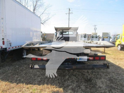 Freightliner M2 106 auto carrier rear view showing flatbed with loading ramps and taillights, VIN 1FVACXFEXKHKD5405 visible on license plate area.
