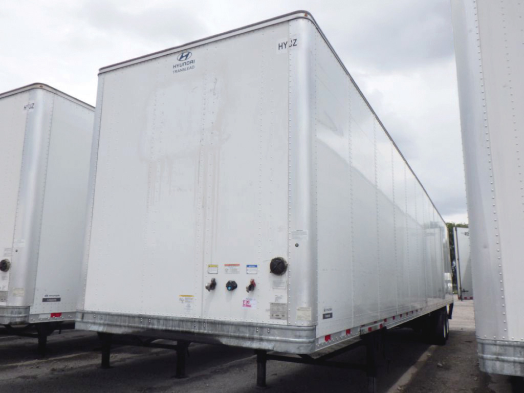 Hyundai Translead dry van trailer showing rear and side with light gray exterior and various control valves near the rear doors.