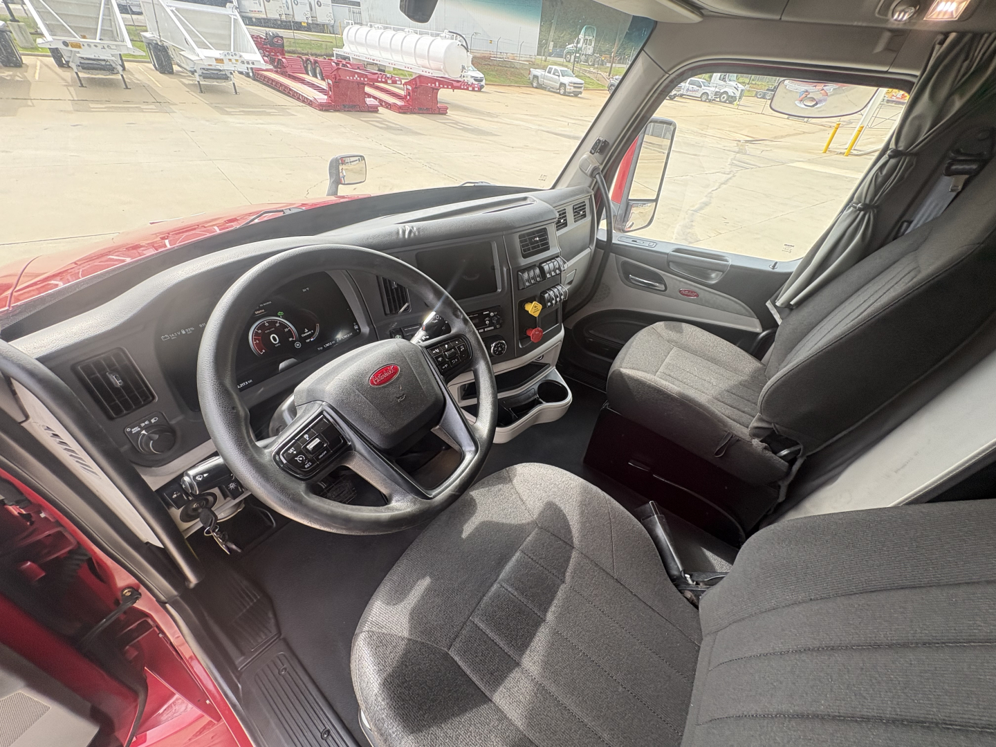 Peterbilt 579 truck cab interior showing steering wheel dashboard and driver seat.