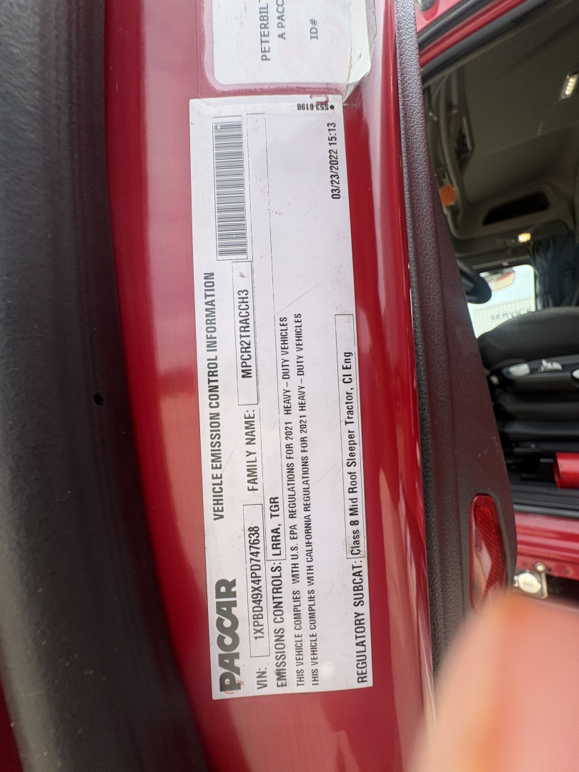 Truck door jamb label showing VIN, stock number, and vehicle information for a Peterbilt 579. Visible text includes PACCAR branding, barcodes, and vehicle emission control information.
