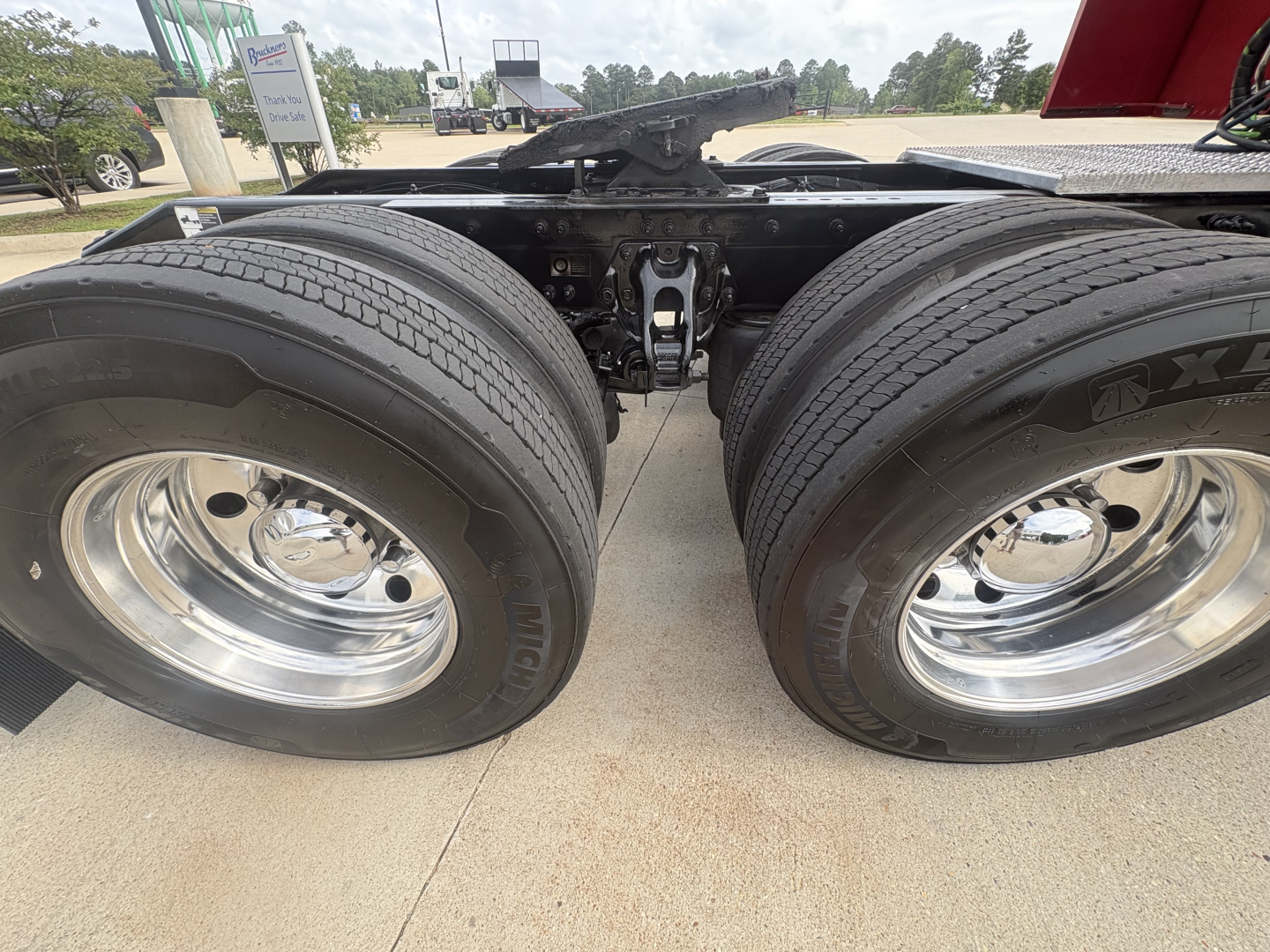 Peterbilt 579 tractor dual rear wheels showing suspension and drive axle assembly with chrome wheels.